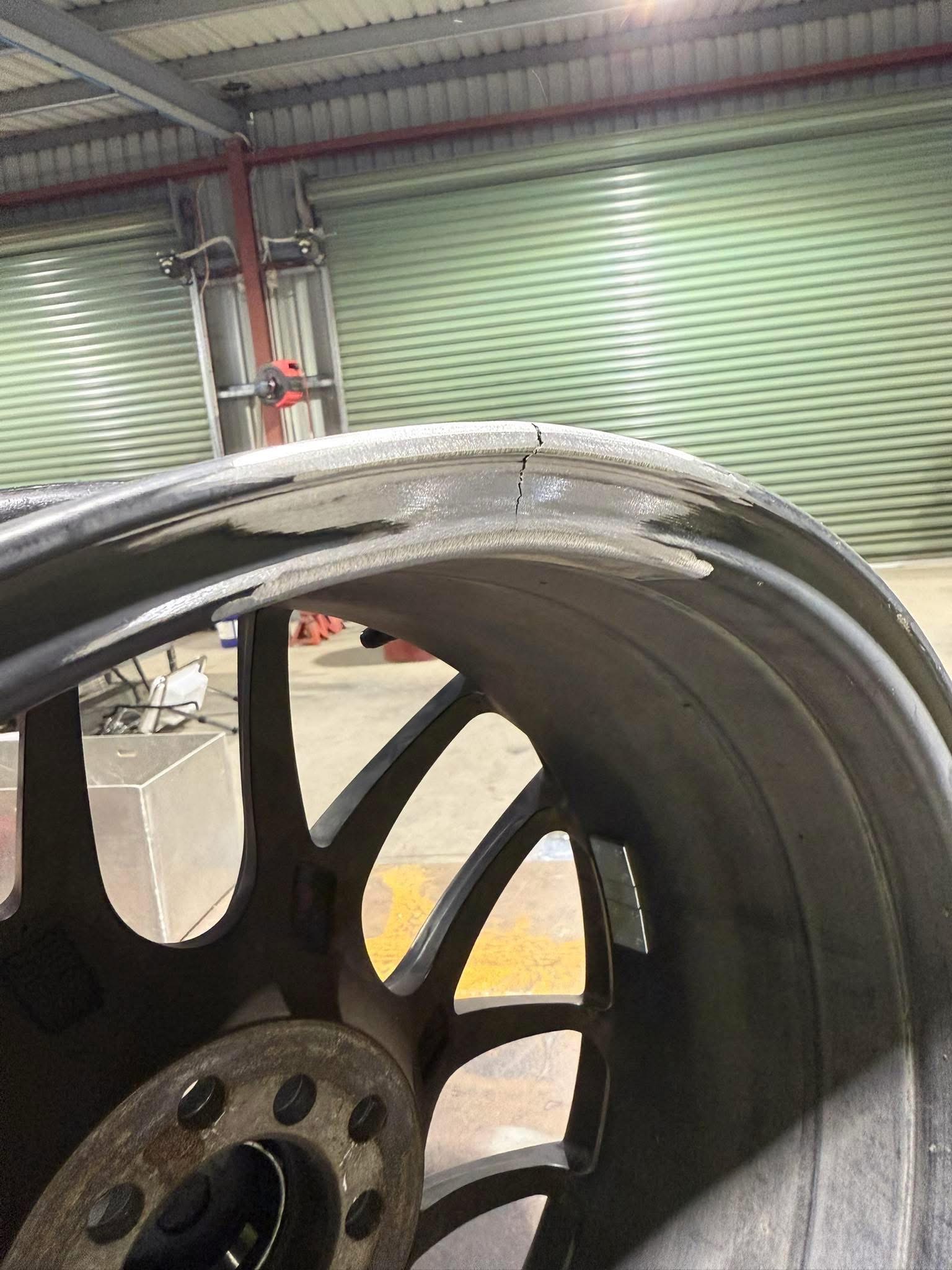 Close-up of a cracked outer wheel lip part way through repair, in the workshop